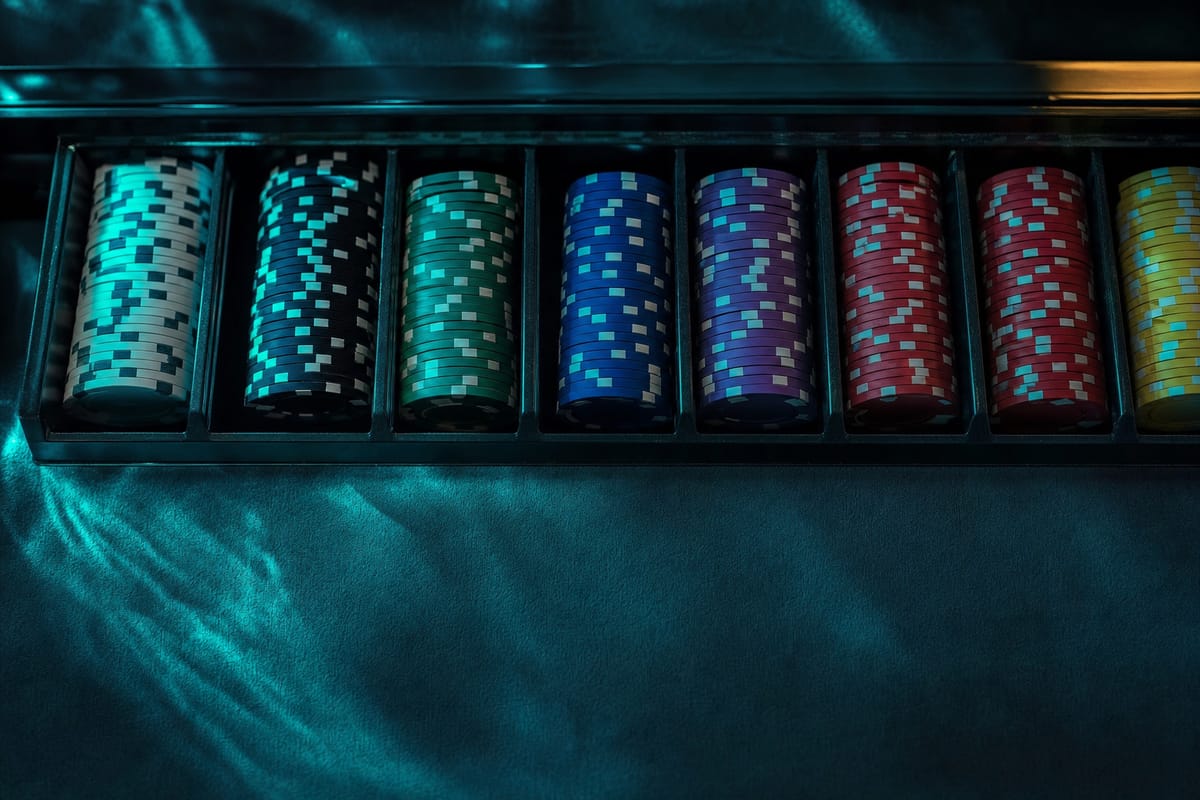 Chip case with rows of stacks sorted by colour, from teal and black through green, blue, purple and red to yellow (AI-generated image)