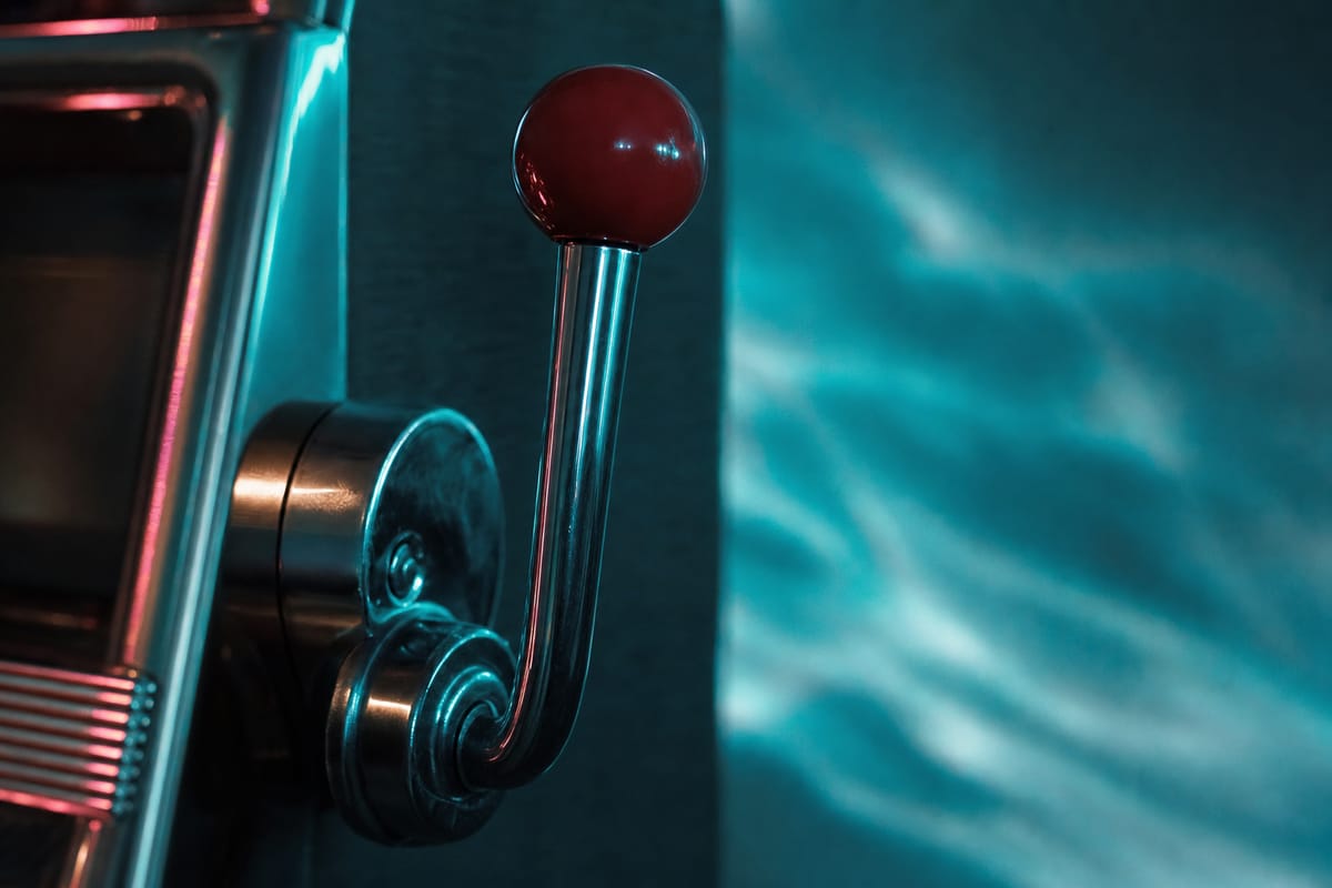 Chrome slot machine lever with a red ball handle on the side of a cabinet, against rippling teal light (AI-generated image)